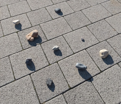 The promenade at Brighton with some white, black and brown beach pebbles laid out in the paving blocks